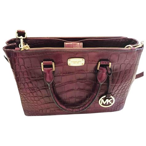 burgundy michael kors bag with burgundy puff ball|Michael Kors wallet maroon.